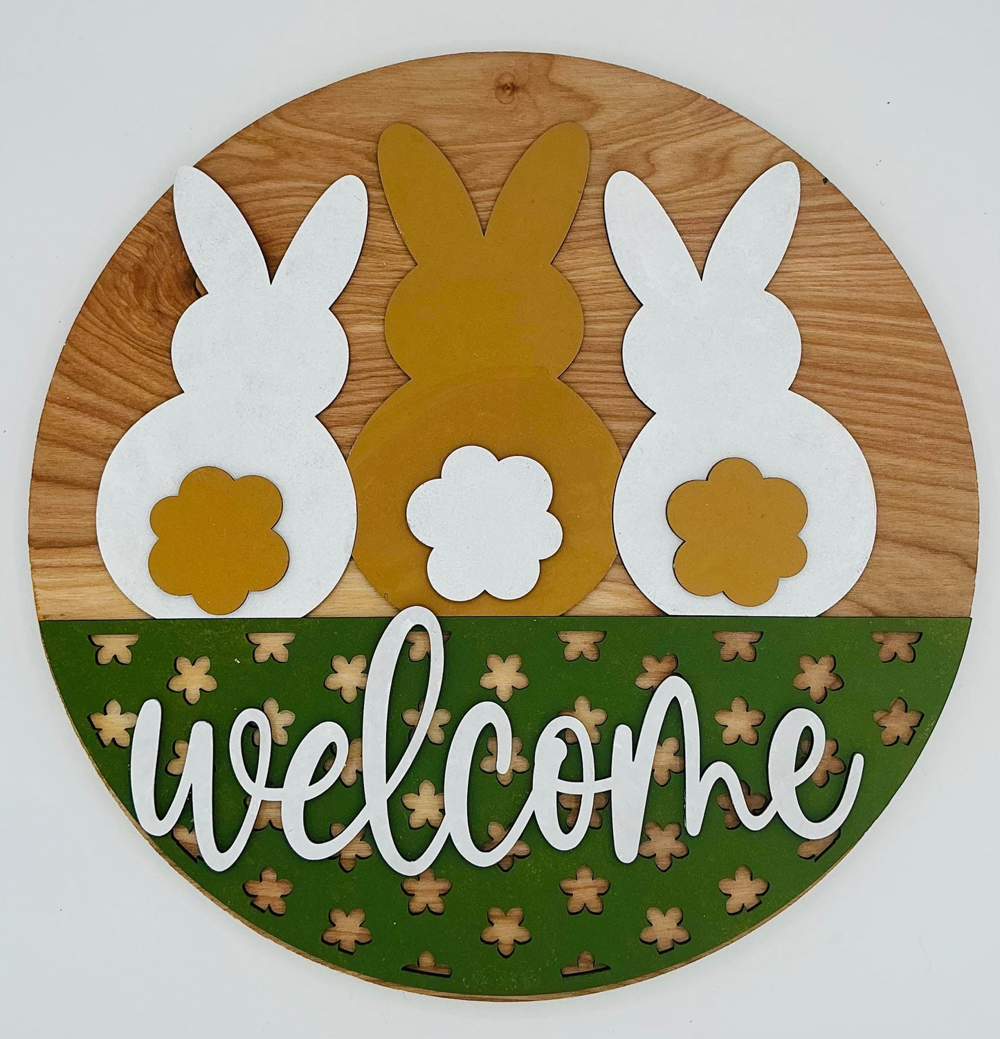 Welcome sign featuring three bunnies in white and gold with green accents for home decor.