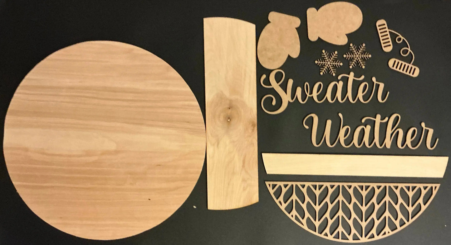 Wooden cutouts of winter-themed items with 'Sweater Weather' text on a black background