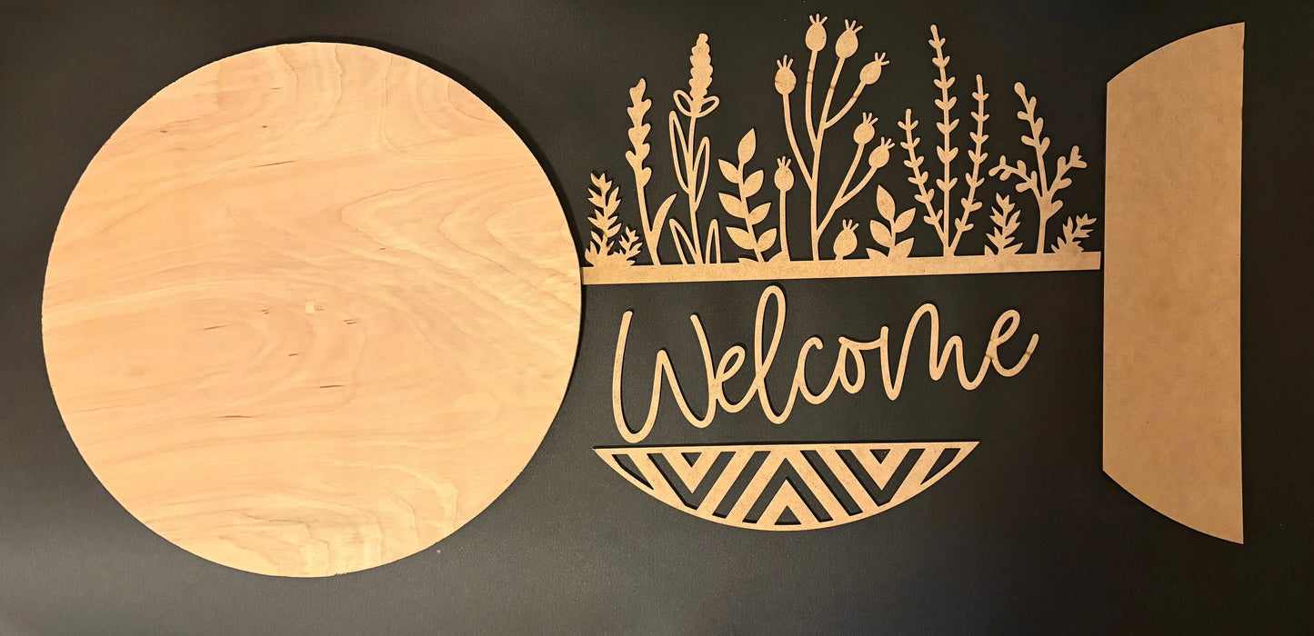 Decorative wall art with plants and 'Welcome' text on a black background