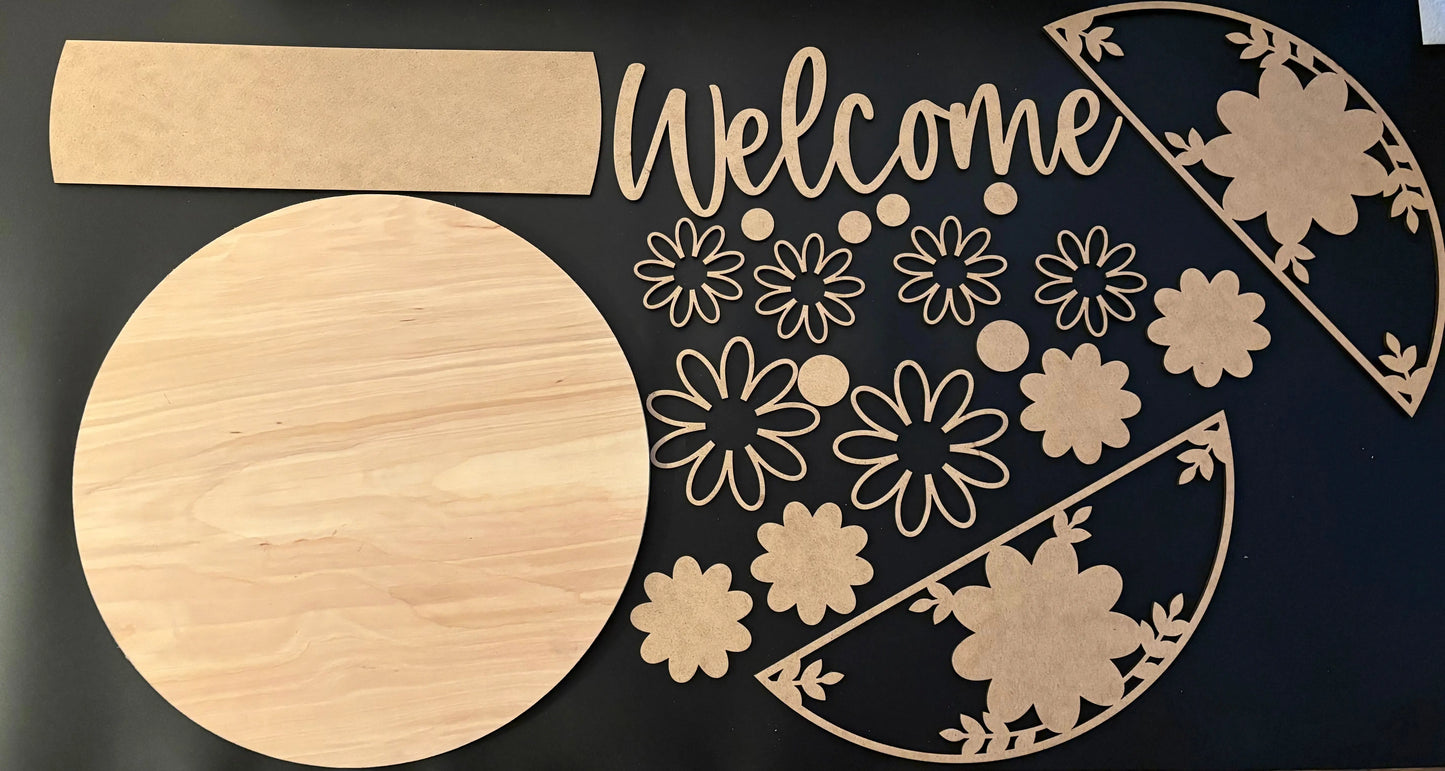 Wooden cutouts of decorative shapes and 'Welcome' text on a black background