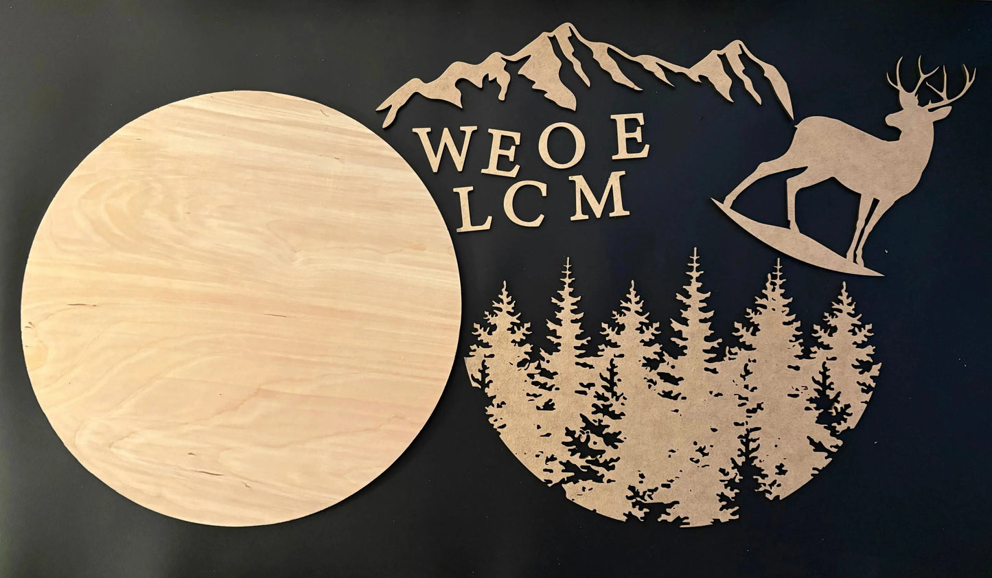 Wooden cutout with welcome text, deer, and trees on a black background