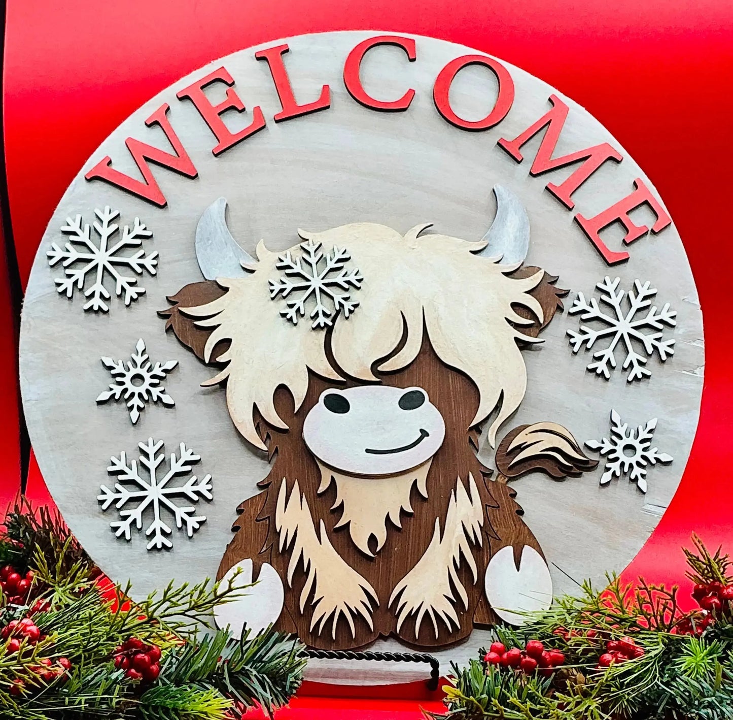 Decorative sign with a yak illustration and snowflakes on a red background