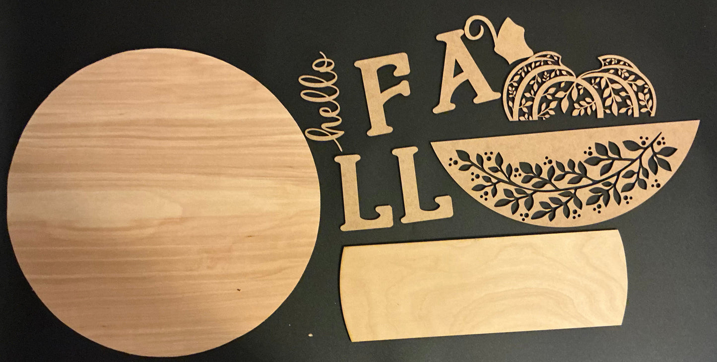 Wooden cutting board with 'hello fall' and pumpkin design on a black background