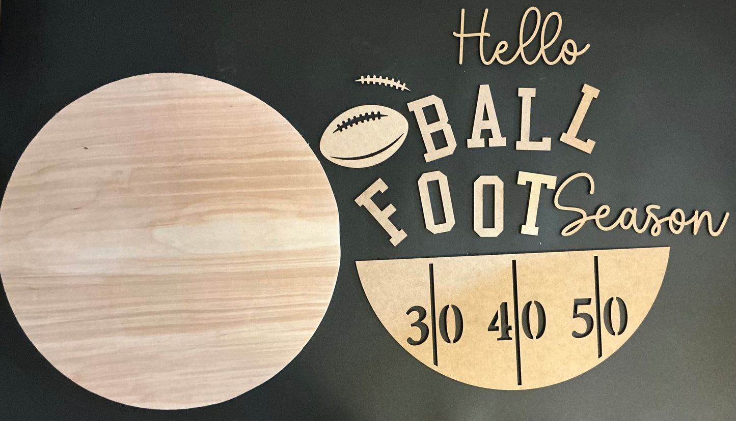 Wooden sign with 'Hello Ball Foot Season' text and football graphic on a dark background