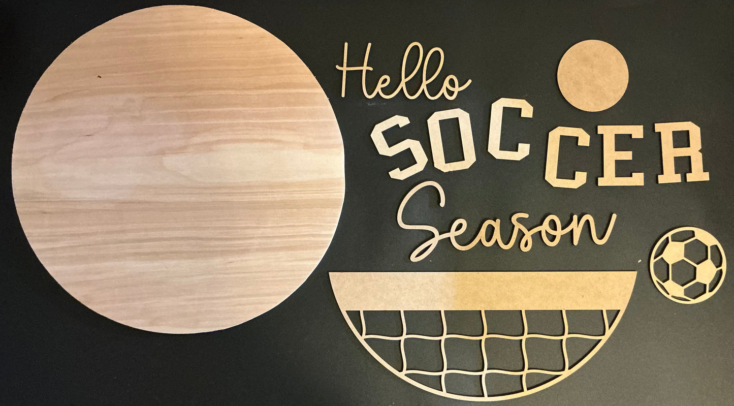Wooden cutout letters spelling 'Hello Soccer Season' on a black background