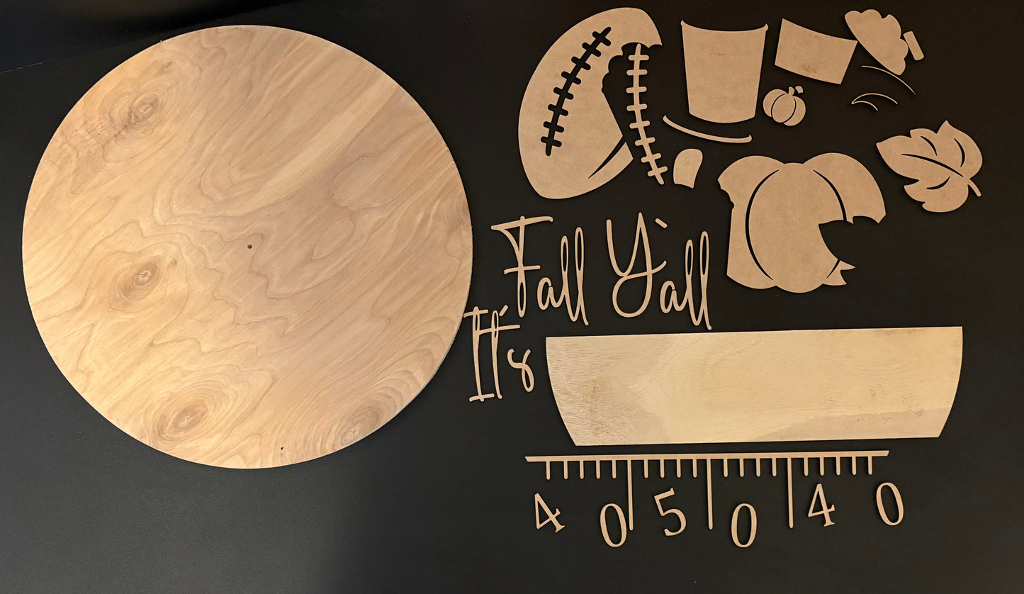 Wooden cutting board with 'It's Fall Y'all' engraving on a black background