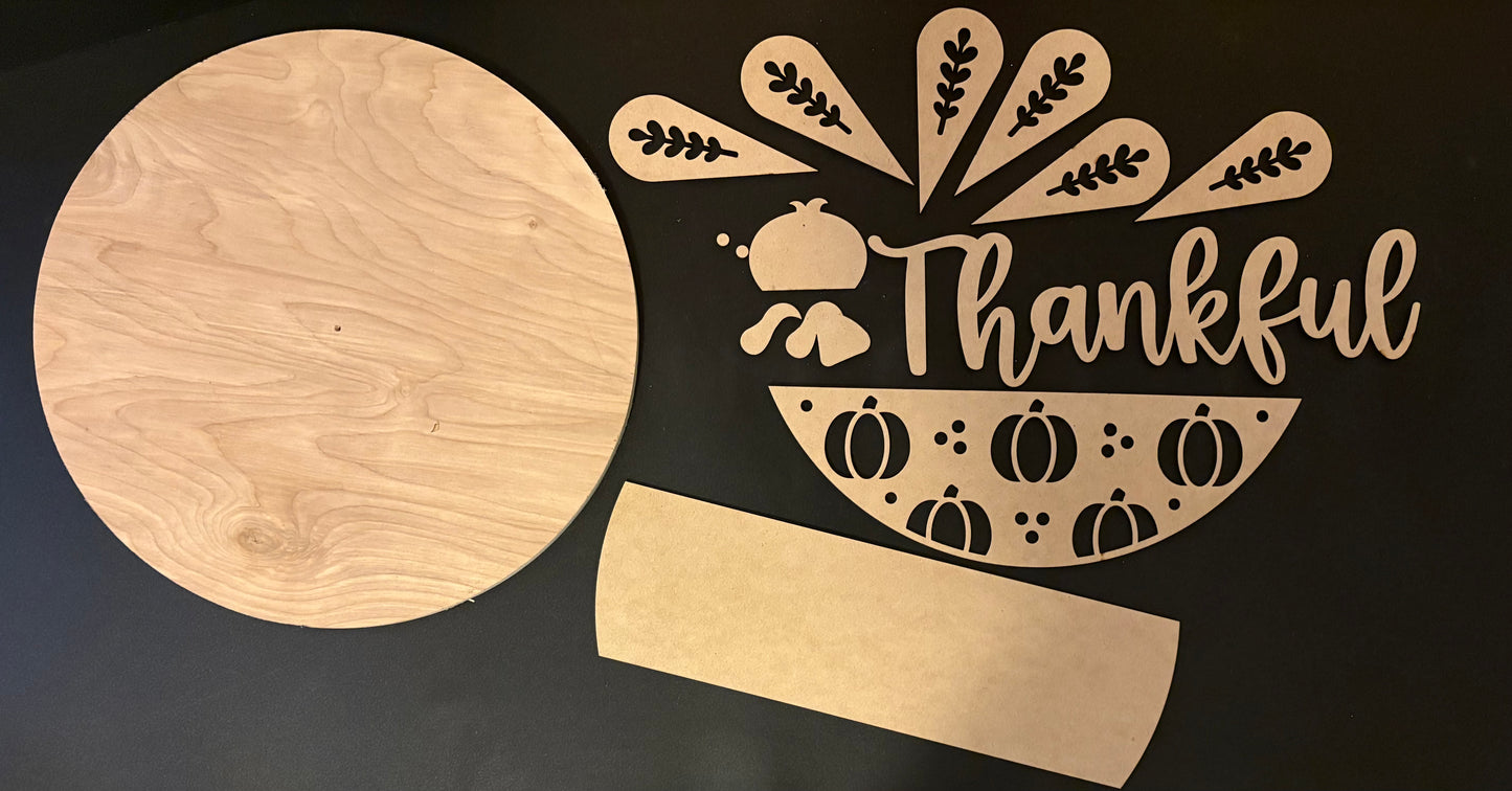 Wooden cutting board with 'Thankful' design on a black background