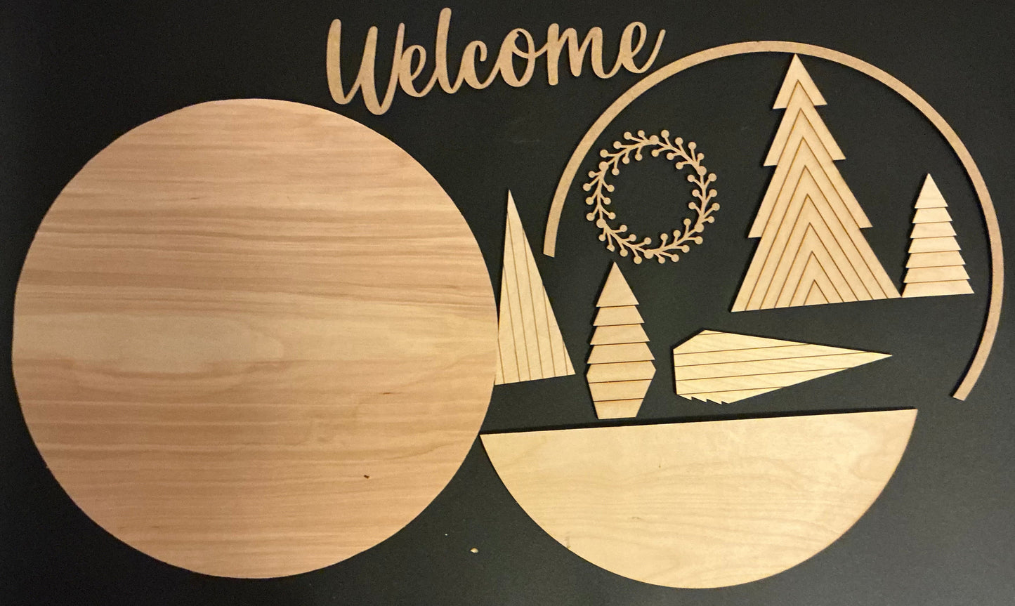 Wooden cutout with 'Welcome' text and Christmas tree designs on a black background