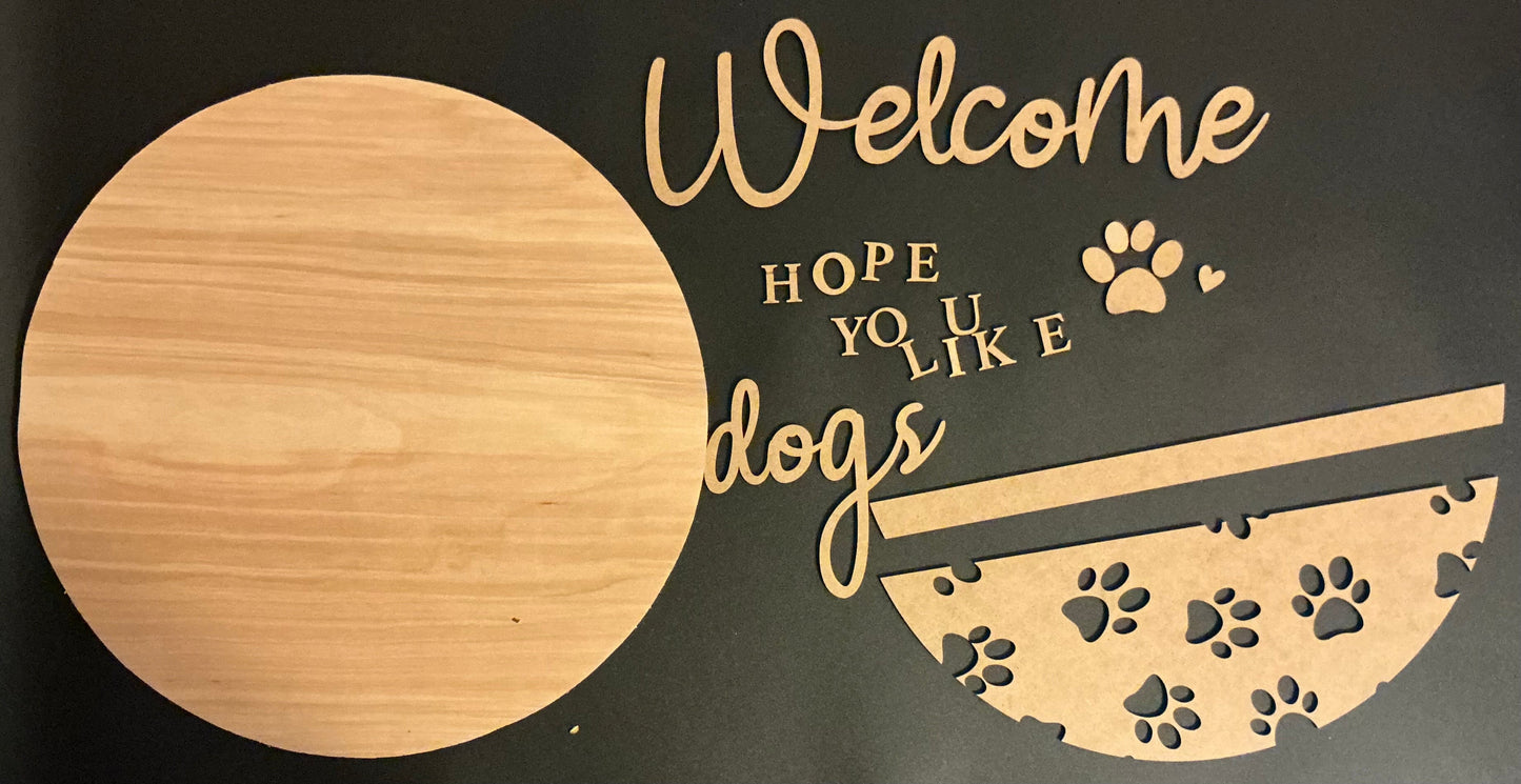Decorative sign with 'Welcome Hope You Like Dogs' text and paw prints on a black background.