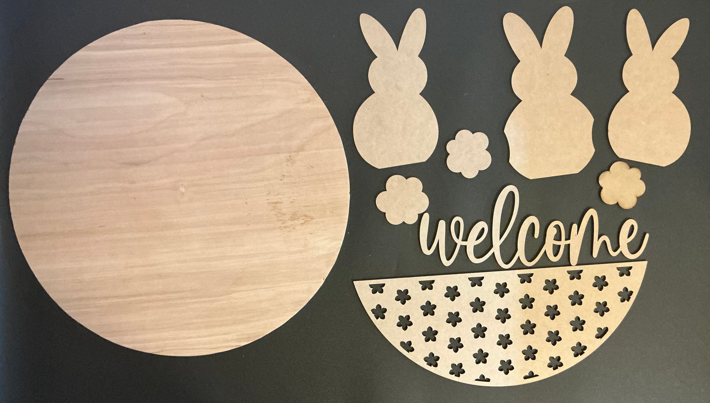 Wooden Welcome sign kit featuring 3 bunny shapes and flower cutouts for spring decor.