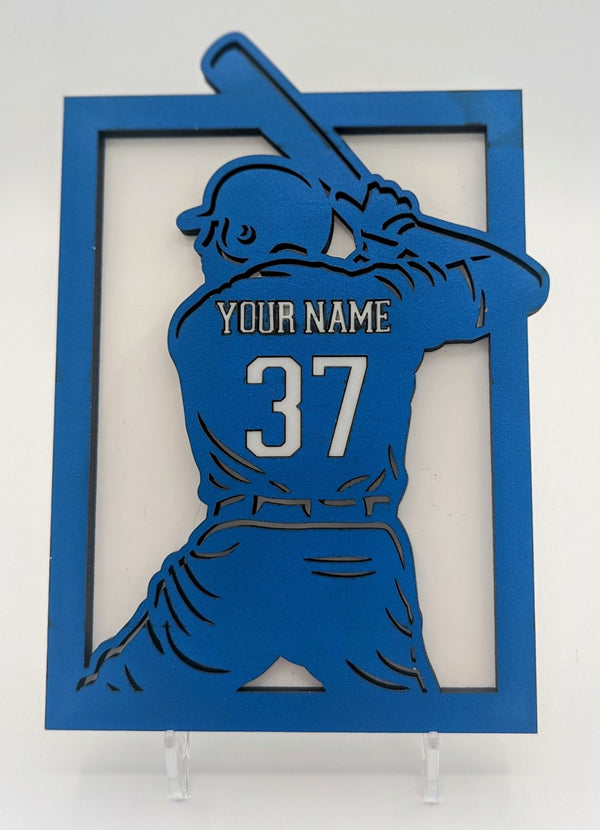 Blue cutout of a baseball player with customizable name and number on a white background