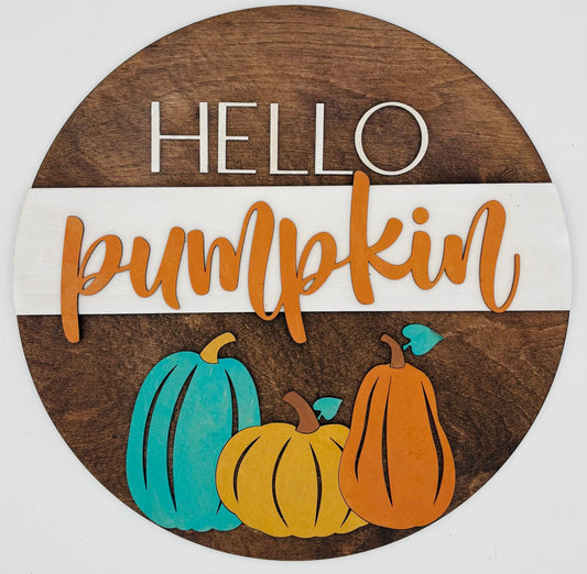 Round wooden sign with 'Hello Pumpkin' text and colorful pumpkins on a white background