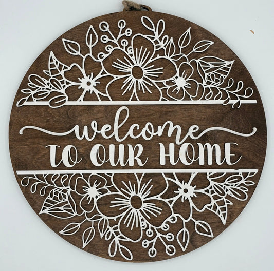 Decorative wooden sign with floral patterns and 'Welcome to our Home' text on a white background