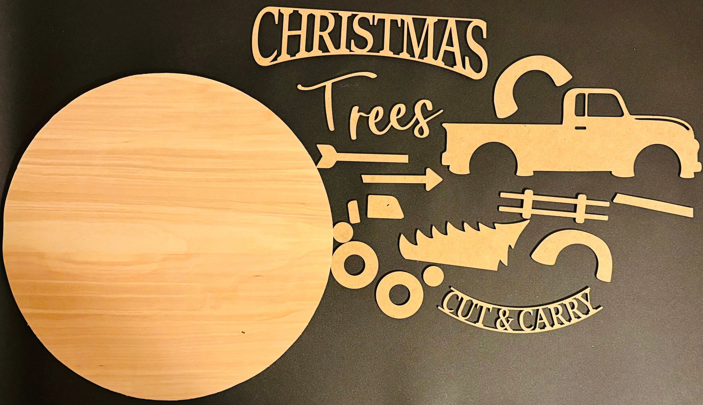 Wooden cutout shapes with Christmas tree and truck designs on a dark background