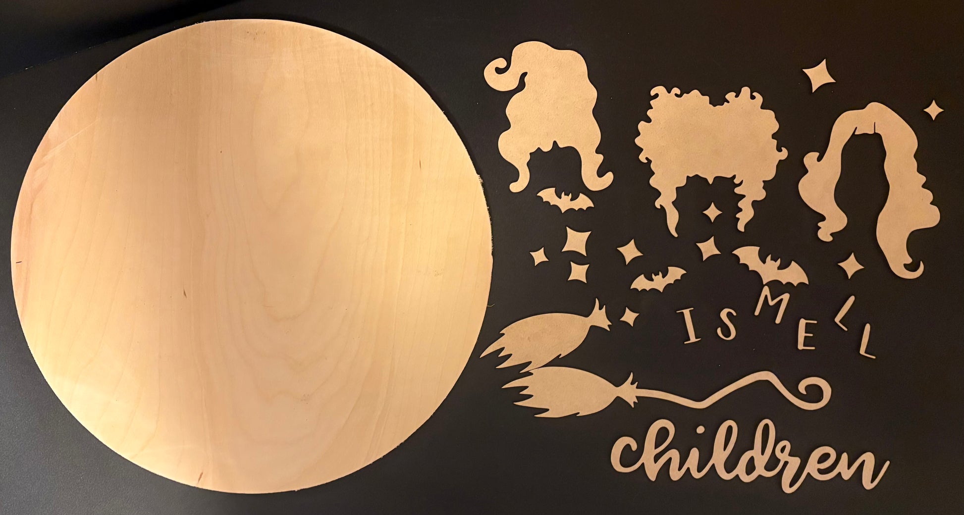 Wooden wall art with decorative cutouts and text on a black background