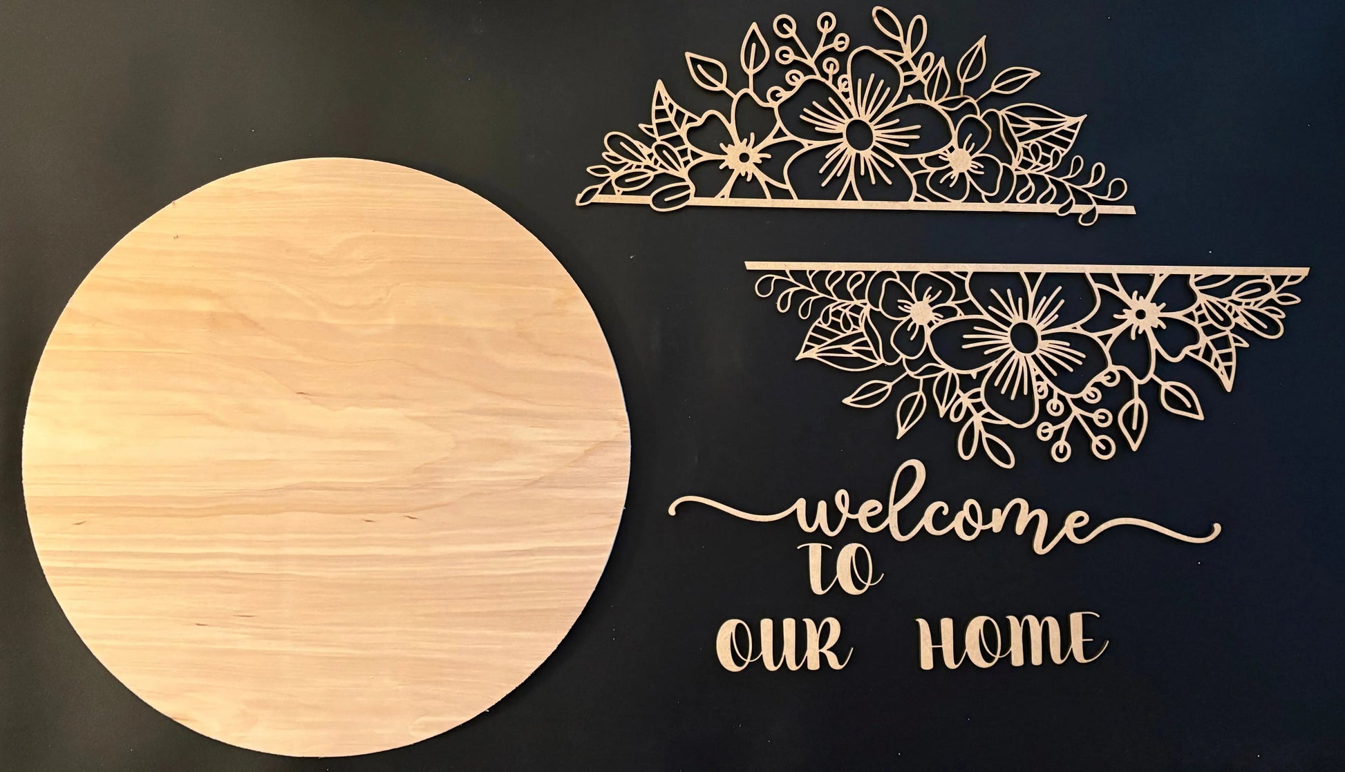 Decorative wooden signs with floral designs and text on a black background