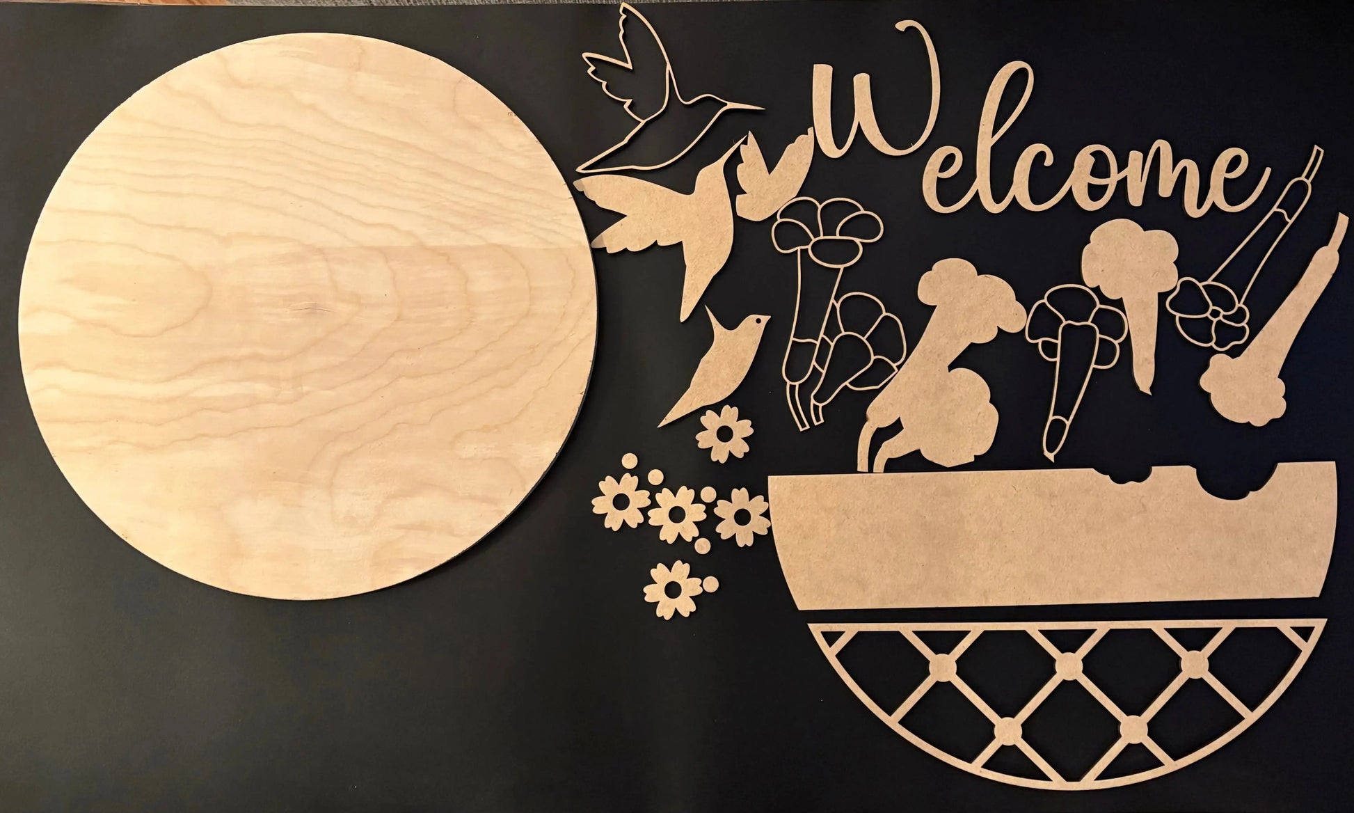 Wooden cutout with 'Welcome' text and decorative elements on a black background