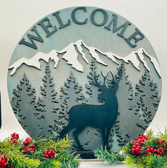 Decorative metal sign with 'WELCOME' and deer design, surrounded by Christmas decorations.
