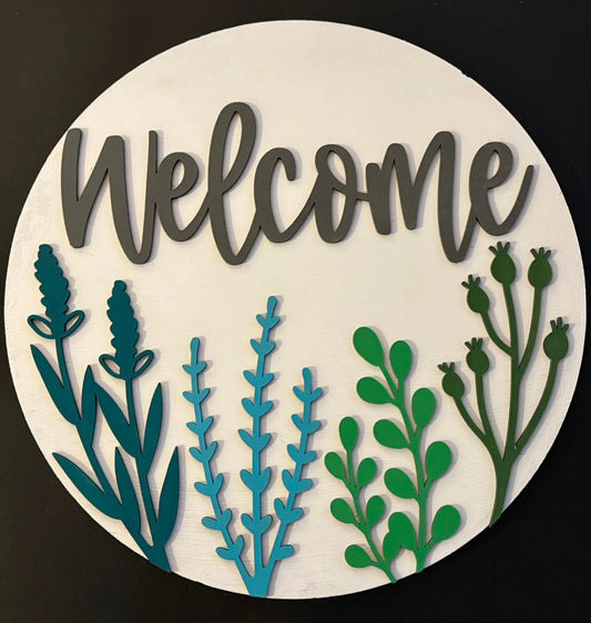 Round wooden sign with 'Welcome' text and green and blue leaf designs on a white background