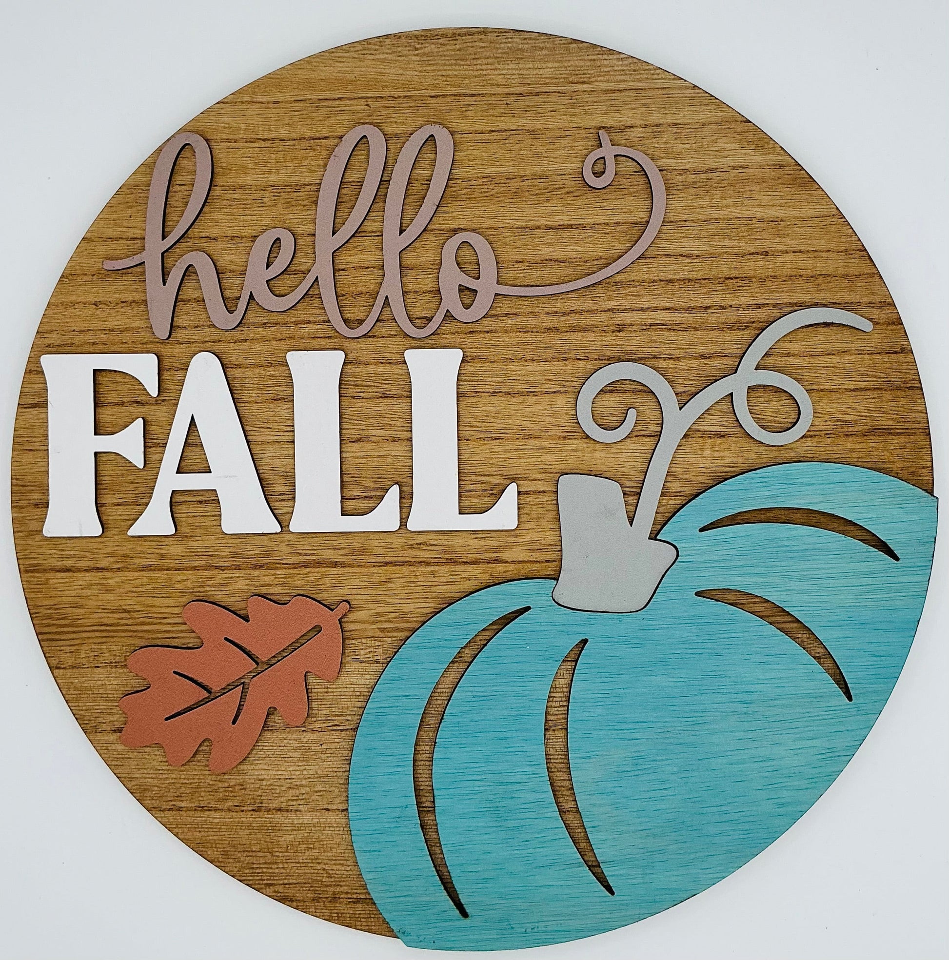 Wooden circular sign with 'hello FALL' text and a blue pumpkin on a white background