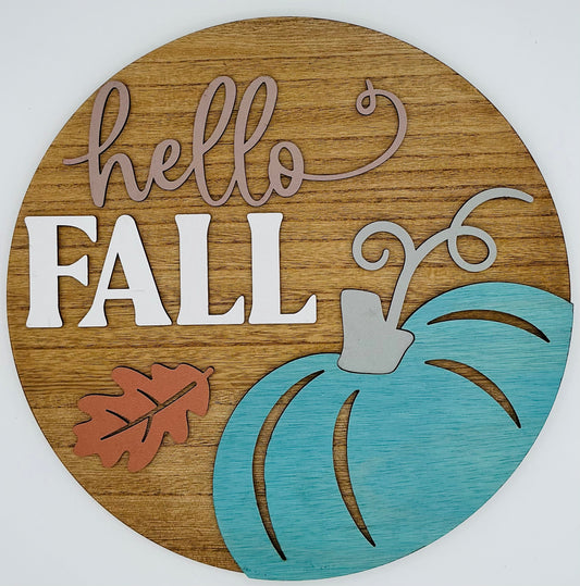 Wooden circular sign with 'hello FALL' text and a blue pumpkin on a white background