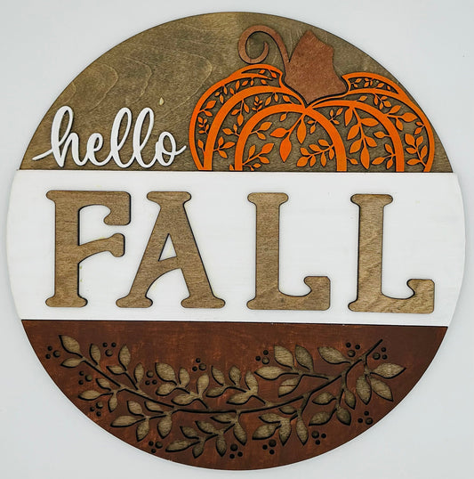 Round wooden sign with 'hello FALL' text and pumpkin design on a white background