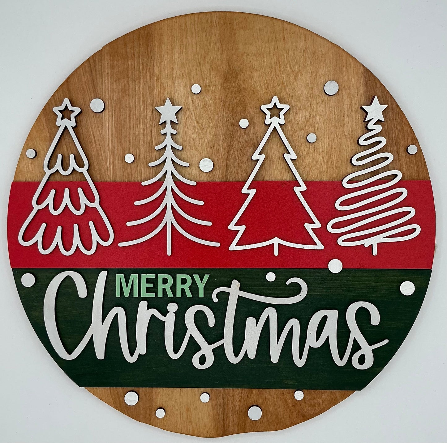 Wooden Christmas decoration with trees and 'Merry Christmas' text on a white background