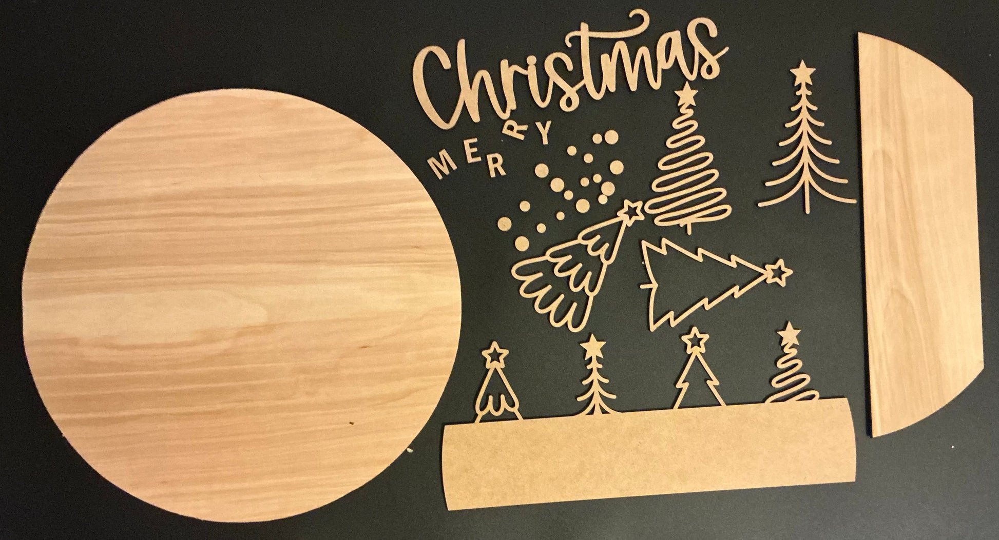 Wooden cutting board with Christmas-themed design on a black background