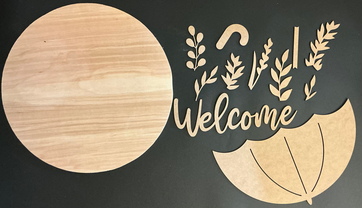 Wooden decorative cutout with 'Welcome' text and leaf designs on a black background